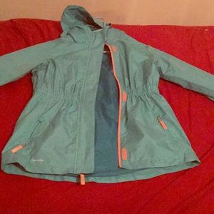 A turquoise Champion rain jacket.